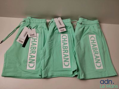 two pairs of mint green pants with white lettering on them