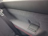 the interior of a car with a seat belt in the center of it