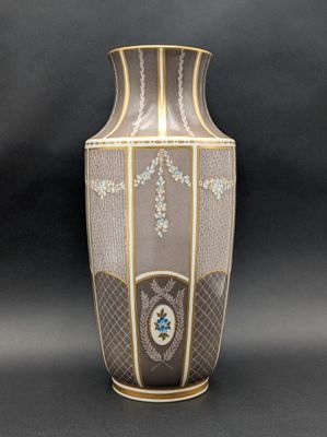 a vase with a cross on it on a black background