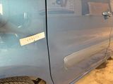 a car with a sticker on the side of it ' s door