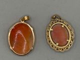 two gold and coral pendants