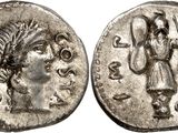 a silver coin with an image of a woman holding a staff