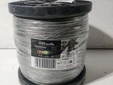 a close up of a spool of wire on a white surface