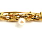 yellow gold plated brooch with a pearl and leaves