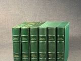 six livres verts empilés les uns sur les autres sur une table