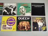 several different album covers are arranged on a white surface
