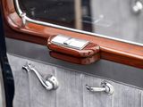 a cell phone that is sitting on the door handle of a car