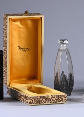 a small glass bottle and a glass salt shaker in a box