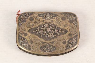 a small metal box with a floral design on it