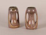two brown vases sitting next to each other on a table