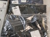 a lot of men ' s shirts on display in the store