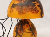 a lamp that has a bird on it on a stand