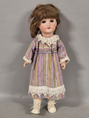 a close up of a doll wearing a dress and boots