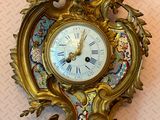 a clock that is on the wall with a bird on it