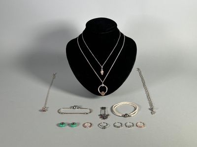 necklaces, bracelets, rings, and other jewelry are displayed on a mannequin