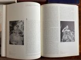 a book open on a table with a picture of a woman