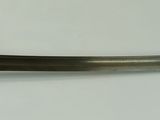 an image of a very old looking sword on a table