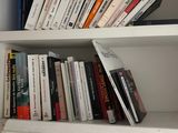 a book shelf with many books on it in a room