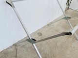a metal rack that is leaning against a white wall