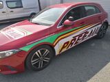 a red car with a green and red design on it