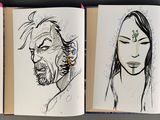 three books with drawings of people on them on a table