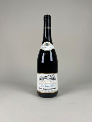 the bottle of wine is sitting on the table