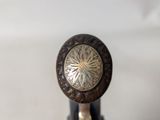 a close up of a wooden handle on a wine bottle