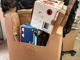 a carton filled with boxes and other items in a garage