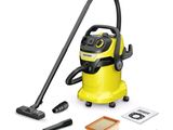 a yellow vacuum cleaner with a black hose and cleaning supplies