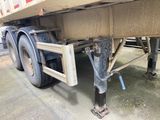 the rear end of a semi truck with a flat bed