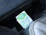 a sticker on the engine of a car that is under the hood