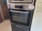 two microwaves stacked on top of each other in the kitchen