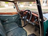 a green car with a steering wheel and a black seat
