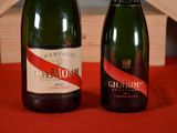 two bottles of champagne sitting next to each other on a table