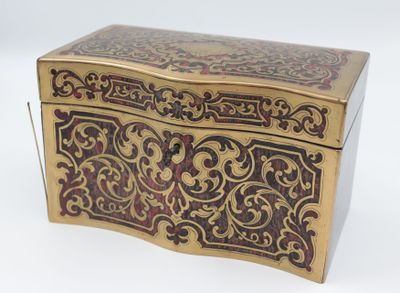 a gold and red box sitting on a white surface