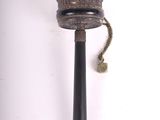 a small metal object with a bell hanging from it