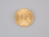 a gold coin on a white surface with a blue background