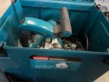 a blue box with tools in it sitting on the floor