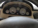 dashboard of a car with a steering wheel and various gauges