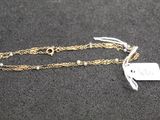 a close up of a necklace with a tag attached to it