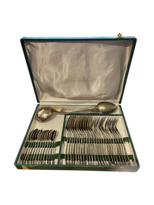 silverware in a green case on a white background
