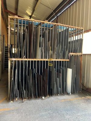 many different types of metal pipes in a warehouse