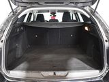 the back of a car with its trunk open and the back seats folded down