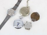 three watches and a watch chain on a white surface