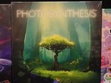 three books of photosyntheics are sitting on a black surface