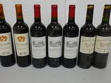 six bottles of wine are lined up on a table