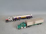 two toy trucks that are sitting next to each other