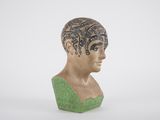 a sculpture of a woman ' s head with a tattoo on it