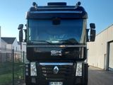 a large black truck parked in front of a building