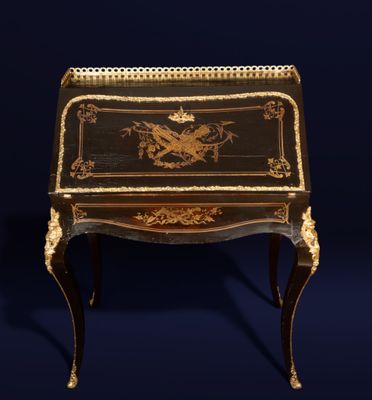 a black and gold painted desk with a dragon on it